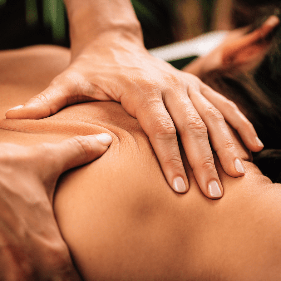 A close-up photo of an acupuncture practitioner's hand holding a needle next to a patient's hand.