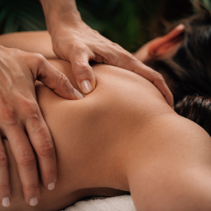 A close-up photo of an acupuncture practitioner's hand holding a needle next to a patient's hand.